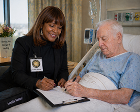 Hospital Notary Philadelphia helping a patient complete bedside notarization for important medical and estate documents